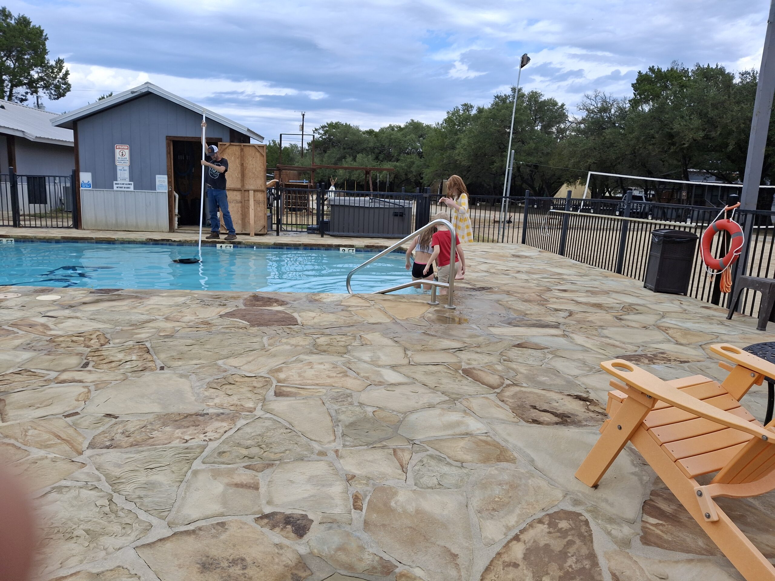 AT THE POOL BEFORE THE RAIN COMES