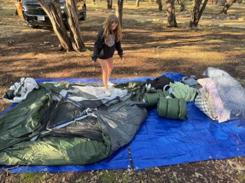 SETTING UP THE TENT ON THE MUD AFTER THE STORM