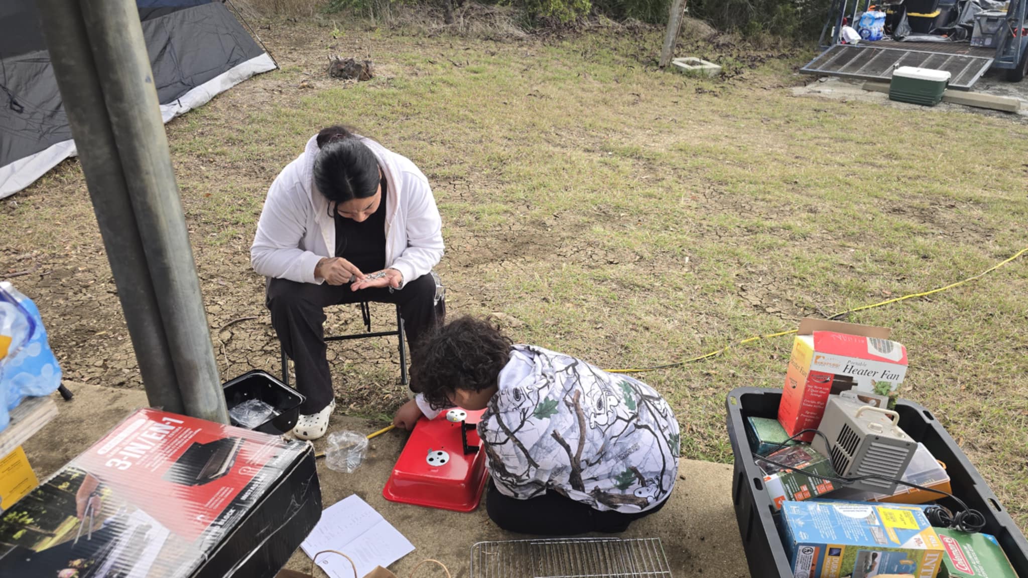 FAMILY BONDING WHILE ASSEMBLING A GRILL